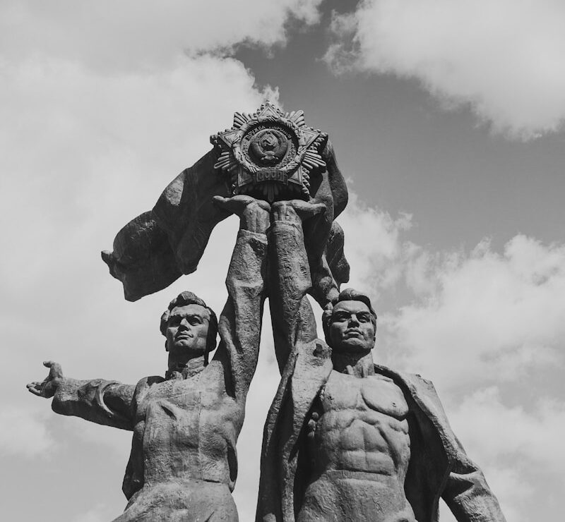 grayscale photo of two men statue